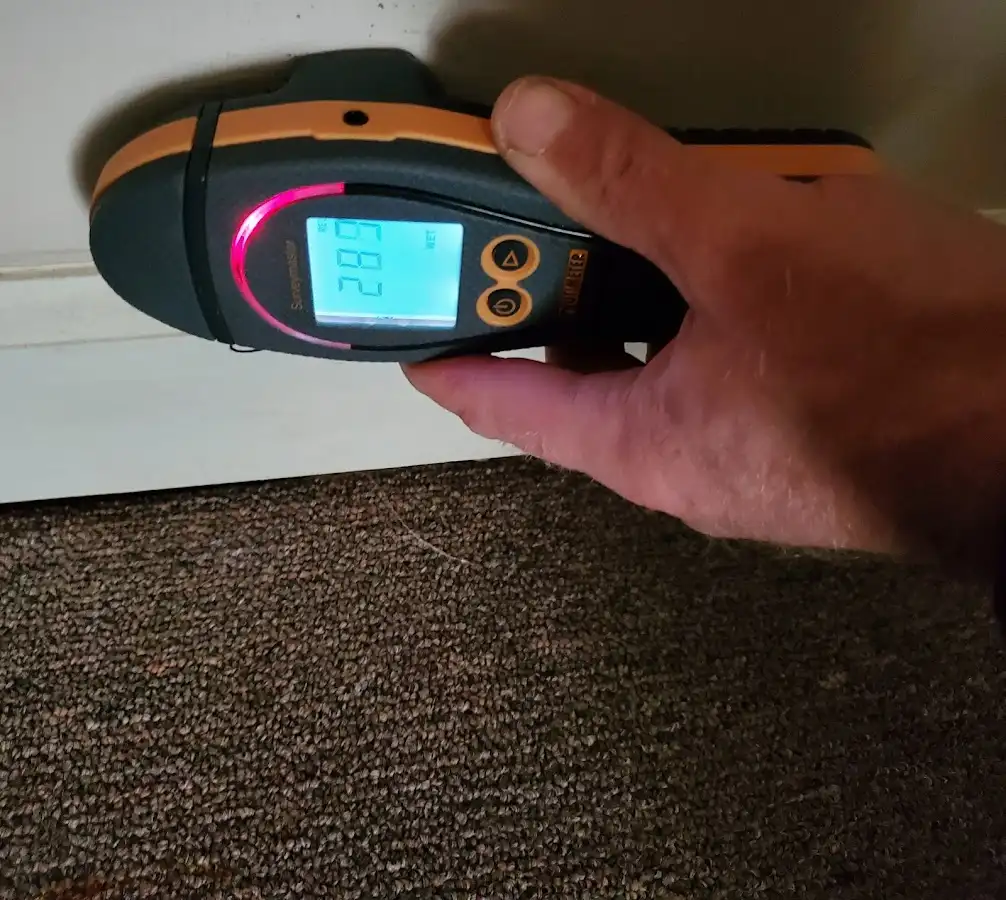 Moisture detection at baseboard during Storm Damage Restoration in Menominee